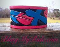 Hand tooled and painted cuff bracelet. Pink and turquoise feather and cross.